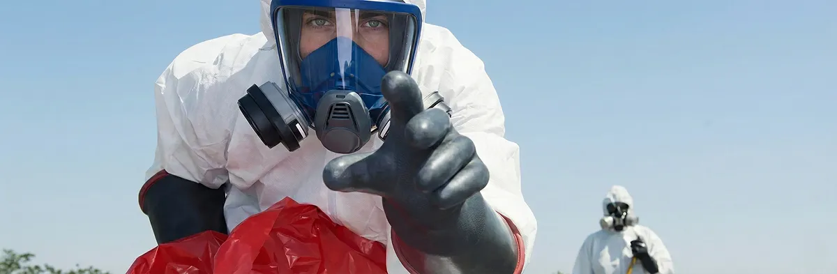 sewage clean up technician wearing protective gear handling biohazard materials in Columbia, MO